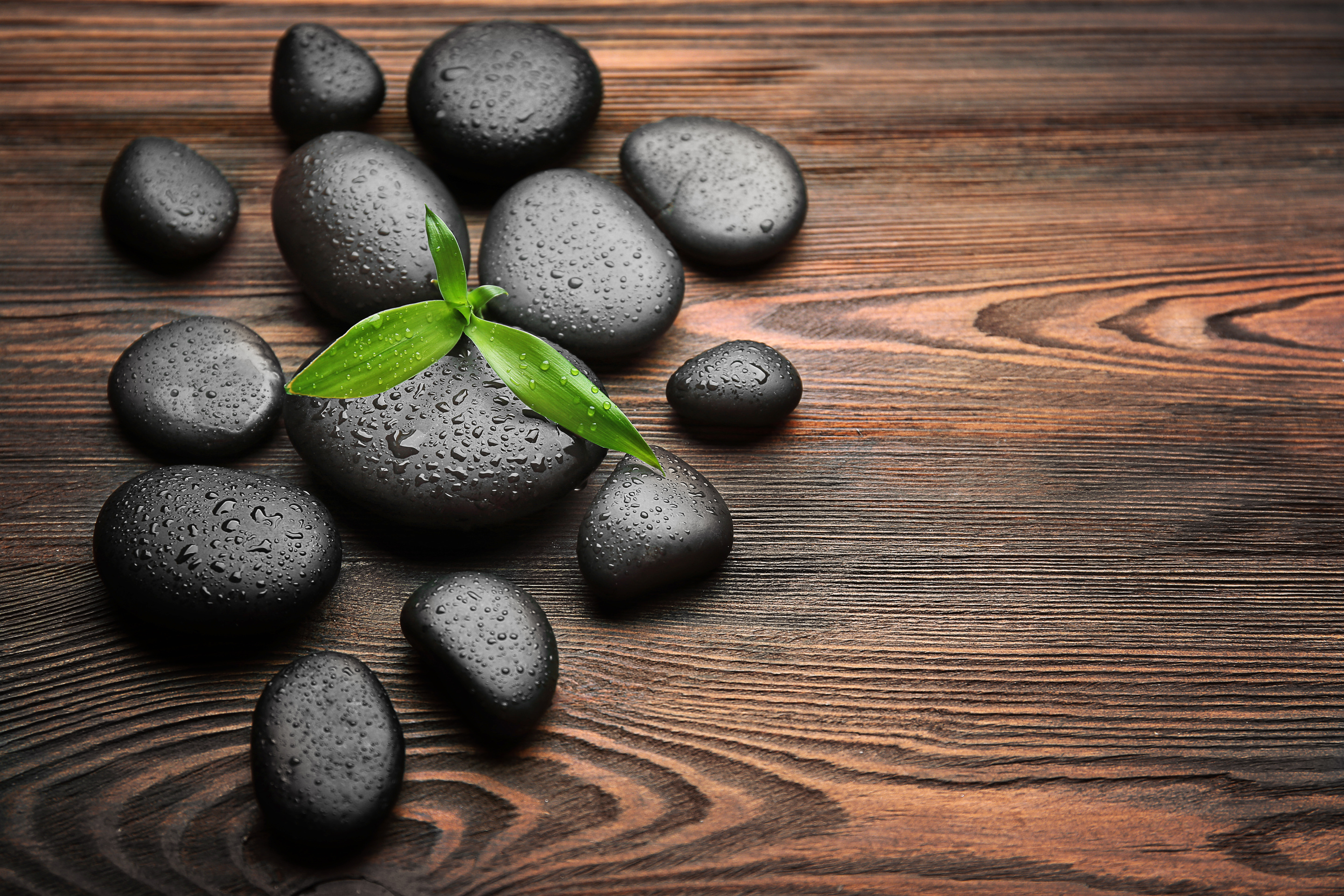 Spa Hot Stones on Wooden Background